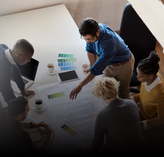 Aerial view of colleagues around a desk